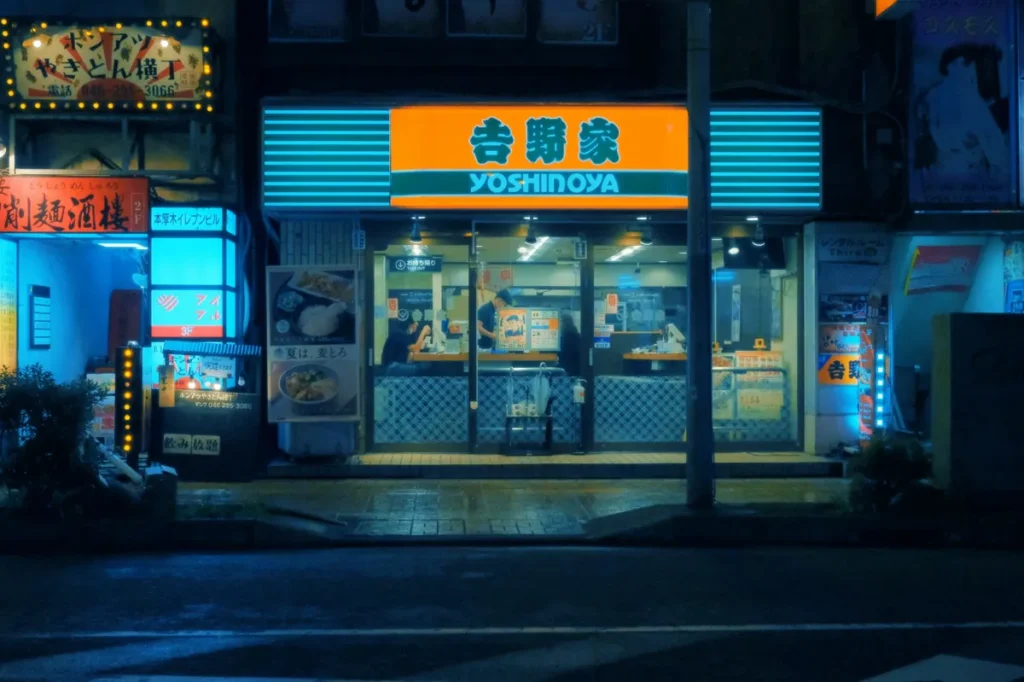 A Yoshinoya restaurant in Japan at night. Known for affordable gyudon beef bowls, Yoshinoya is one of the most common fast-food chains frequented by locals across Japan.